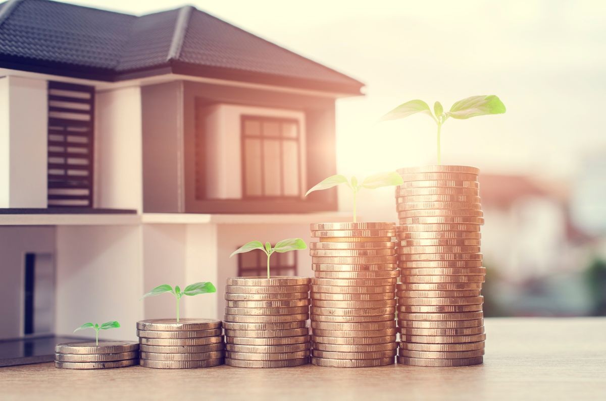 Growing investment concept with coin stacks and green sprouts against a model home backdrop, highlighting the growth potential and profitable project investment opportunities at Luxe Living Homes. Growing investment concept with coin stacks and green sprouts against a model home backdrop, highlighting the growth potential and profitable project investment opportunities at Luxe Living Homes.